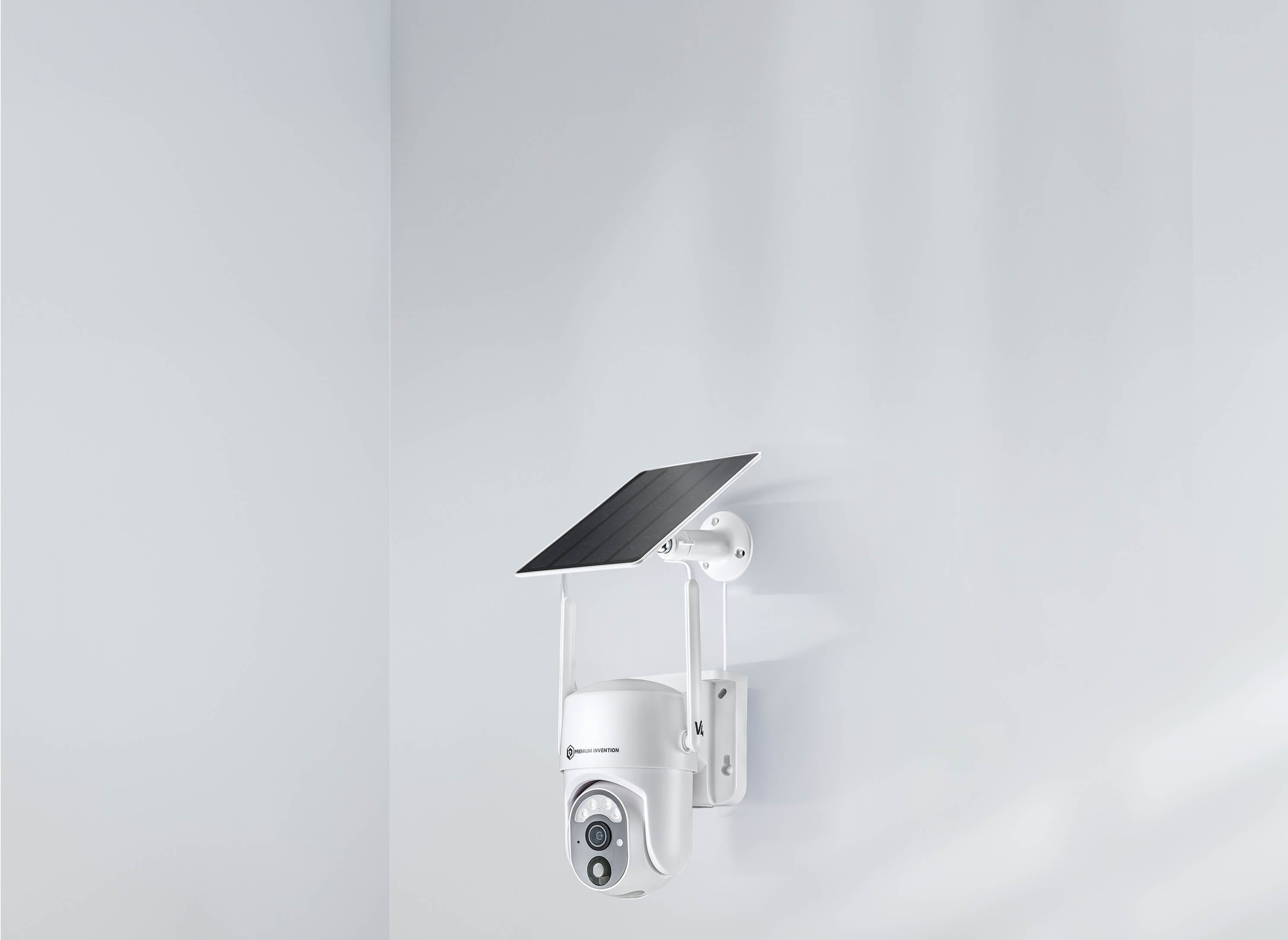 White camera mounted on a wall with a solar panel, featuring Premium Invention's Wireless V4 for enhanced surveillance.